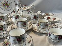 Close-up of teacups, saucers, side plates, serving tray