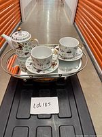 Entire set: teapot, 2 cups, 2 saucers displayed on mirror tray (tray not included)