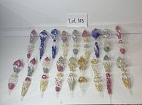 All 18 glass icicle ornaments laid flat, showing colour variety