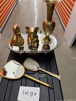 All five items grouped: vase, duck bookend, teddy bear figurine on tray; vanity mirror and brush in foreground