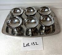 Top view of six cups arranged on tray