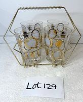 Front view of four Glen Echo glasses in gold-tone caddy