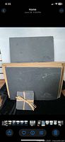 Front view of two slate boards and bundled coasters