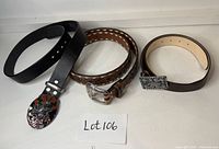 Overview of three leather belts displayed side by side