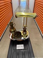 All three items grouped: brass banker’s lamp, bronze vase, bronze bookend