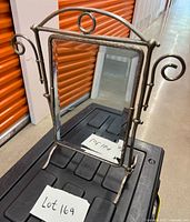 Front view of stainless steel tabletop mirror showing full frame and feet