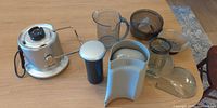 All components laid out: motor base, food pusher, juice jug, pulp bin, lid, filter basket