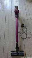 Full view of Dyson V7 Motorhead stick vacuum with charger