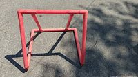 Front view of red PVC skate trainer showing frame