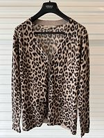 Front view of leopard print cardigan on hanger