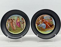 Front view pair plates showing painted scenes and black borders