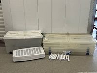 Overall view of three bins, lids, shelf panel, tube supports