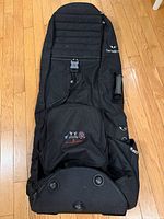 Full view of black Samsonite soft golf travel bag laid flat