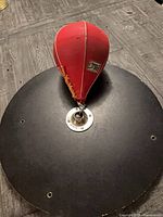 Top view of red speed bag mounted to black circular platform