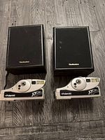 Lot overview showing two Polaroid JoyCam cameras and two Technics speakers