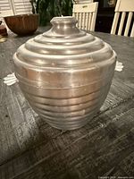 Front view of ribbed hammered aluminum ice bucket with lid in place