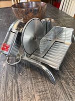 three-quarter front view showing blade, motor, food carriage