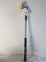 Full view of telescoping wand showing overall length, grip, and spray head