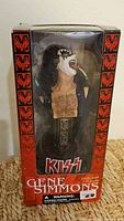 Front view of packaged Gene Simmons statuette in KISS box