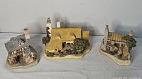 Group shot of all three David Winter cottage figurines