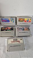 Front view of the five Super Famicom cartridges showing game labels