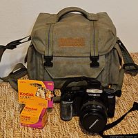 Camera, lens, bag and film boxes overall view