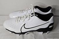 Side profile of both cleats showing exterior design and molded cleats