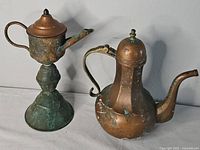 Both teapots side by side showing overall form and patina