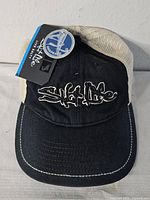 Front view showing embroidered logo, brim, and hangtag