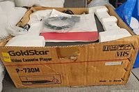 Boxed GoldStar P-730M VHS player showing model and packaging