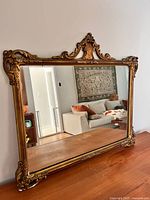 Full view showing rectangular mirror and decorative crest