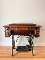 Cabinet closed front view with treadle base