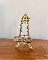 Front view of ornate brass easel