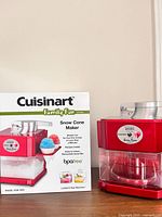 Snow cone maker next to branded box