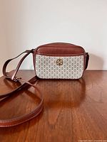 Front view of Fossil Brennon bag showing logo panel and strap