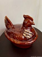 Side view of assembled hen casserole showing overall form and glaze