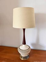 Full view of table lamp with replacement shade on wooden surface