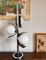 Lamp unlit showing chrome structure, three glass globes, base