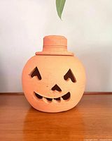 Full front view of terracotta jack-o’-lantern
