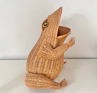 Front side view of wicker frog basket showing shape and eyes