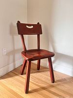 Full view of Cushman chair angled in corner showing overall design