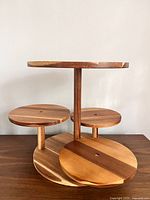 Full view of wooden dessert stand showing all four tiers and central support