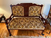 Full view of settee front showing frame, upholstery and casters