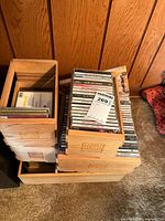 Stacked wooden cigar boxes filled with CDs