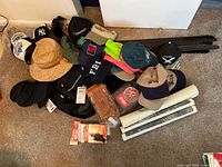 Overview of hats, belts, Marlboro gear, posters, bag, patch on carpet