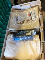 Locker interior showing sealed canvas drop cloth packages, blue rolled tarp and folded used cloths