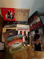 Group shot of stack of 16 record jackets showing several identifiable titles