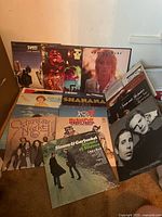 Group of several album jackets spread out showing majority of titles