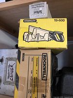 Stacked boxed items: Vanguard TapTight kit, Stanley 19-600 mitre box with backsaw, Rockwell Jawhorse RB9206