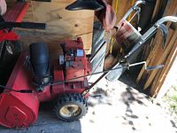 Full left-side view showing housing, engine, handles and chute